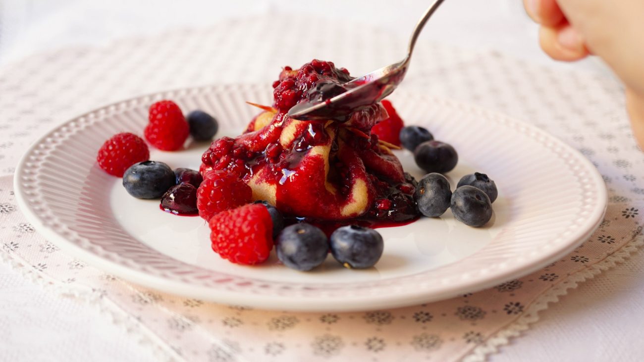 Crepes with yogurt and berries flambé